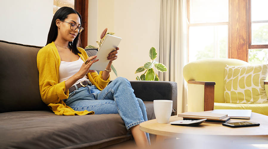 girl sitting on couch looking at her phone