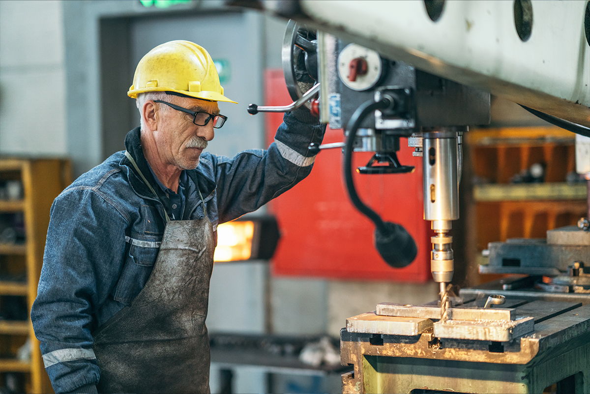 man operating machinery in a factory